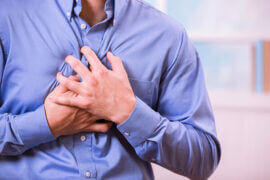 Man holding heart in pain